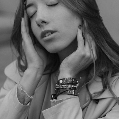 Person sitting in a meditative pose with a calm expression.